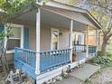House exterior featuring a covered porch with blue railings and landscaping at 108 W 650 South, Pendleton, IN 46064