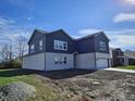 Two-story home showcasing a side view and landscaping at 525 Schmitt Rd, Indianapolis, IN 46239
