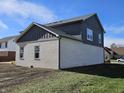 Rear view of home showcasing white brick and dark gray siding at 525 Schmitt Rd, Indianapolis, IN 46239