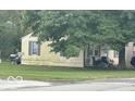 Tan house side view with landscaping at 3816 St Charles St, Anderson, IN 46013