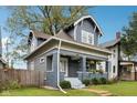 Renovated craftsman home with gray exterior, white trim, and a spacious front yard at 3005 Broadway St, Indianapolis, IN 46205