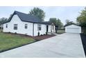 Charming home exterior with detached garage and landscaping at 2068 S Avon Ave, Avon, IN 46123