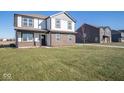 Two-story house with a front yard and a neighboring home at 7888 Magnolia St, New Palestine, IN 46163