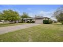 Brick ranch home with attached garage and spacious lawn at 1061 Saint Paul St, Shelbyville, IN 46176