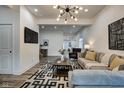 Modern living room with gray sectional sofa and statement lighting at 1229 N Keystone Ave, Indianapolis, IN 46201