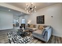 Open living area featuring a gray sectional and kitchen view at 1229 N Keystone Ave, Indianapolis, IN 46201