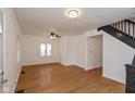 Bright living room with hardwood floors, ceiling fan, and view of staircase at 309 N Lasalle St, Indianapolis, IN 46201