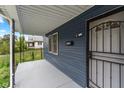 Covered porch with a metal security door and gray flooring at 309 N Lasalle St, Indianapolis, IN 46201