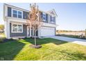Two-story home with gray siding, white trim, and a two-car garage at 1561 Hanover St, Danville, IN 46122