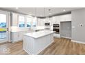 Modern kitchen featuring white cabinets, a center island, and stainless steel appliances at 7306 W County Road 600 Rd # 14-602, McCordsville, IN 46055