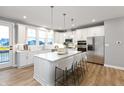 Modern kitchen with white cabinets, island, and stainless steel appliances at 7306 W County Road 600 Rd # 14-602, McCordsville, IN 46055