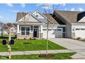 Charming craftsman home with gray siding, stone accents, and a two car garage at 10618 Maidenhair Dr, Indianapolis, IN 46239