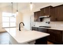 Modern kitchen with dark cabinets, white quartz countertops, and gas range at 3657 Sycamore Bend S Way, Columbus, IN 47203