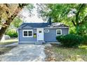 Gray house with white trim, small porch and yard at 2035 N Tibbs Ave, Indianapolis, IN 46222