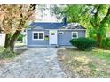 Newly renovated gray house with a front yard and driveway at 2035 N Tibbs Ave, Indianapolis, IN 46222