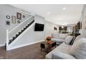 Living room with hardwood floors, sectional sofa, and stairs to the upper level at 6129 Crittenden Ave, Indianapolis, IN 46220