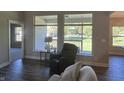 Relaxing living room with hardwood floors, large windows, and access to backyard at 1230 Thorndon Ct, Danville, IN 46122