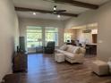 Spacious living room with hardwood floors, exposed beams, and comfortable seating at 1230 Thorndon Ct, Danville, IN 46122