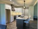 Modern kitchen with white shaker cabinets, granite countertops, and a large island at 1230 Thorndon Ct, Danville, IN 46122
