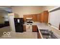 Kitchen with wood cabinets, and stainless steel appliances at 5347 Waterton Lakes Dr, Indianapolis, IN 46237