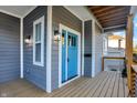 Inviting front entrance with a bright blue door and a wooden porch at 515 Orange St, Indianapolis, IN 46203