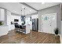 Modern kitchen with white cabinets, a kitchen island and hardwood floors at 515 Orange St, Indianapolis, IN 46203