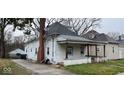 Side view of the house, showcasing the exterior details and landscaping at 712 W Queen St, Muncie, IN 47303