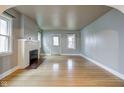 Light gray walls, hardwood floors, and a fireplace at 971 N Lesley Ave, Indianapolis, IN 46219