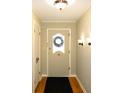 Bright entryway with hardwood floors and wreath at 6205 Bramshaw Rd, Indianapolis, IN 46220