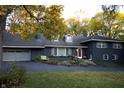 Ranch home with dark blue exterior and landscaping at 6205 Bramshaw Rd, Indianapolis, IN 46220
