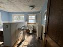 Bathroom with pedestal sink, toilet, and tiled floor at 548 Central N Ct, Indianapolis, IN 46205