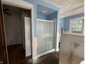 Small bathroom with shower, partial wall, and wood floor at 548 Central N Ct, Indianapolis, IN 46205