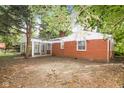 Rear view of house highlighting screened porch and yard at 3226 W 46Th St, Indianapolis, IN 46228