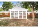 Screened porch with brick exterior and leafy green surroundings at 3226 W 46Th St, Indianapolis, IN 46228