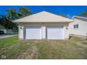 Detached two-car garage with white doors and light-yellow exterior at 2682 E 150 S, Anderson, IN 46017