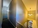Upper hallway with gray walls, carpet, and chandelier at 4839 Alameda Rd, Indianapolis, IN 46228