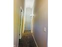 Gray-walled hallway with carpet and multiple doors at 4839 Alameda Rd, Indianapolis, IN 46228