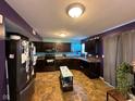 Spacious kitchen with dark cabinetry and tile flooring at 7625 Firecrest Ln, Camby, IN 46113