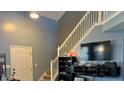Staircase and TV setup in the entryway at 7625 Firecrest Ln, Camby, IN 46113