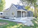 Newly renovated grey house with a front porch at 1521 Indiana Ave, Columbus, IN 47201
