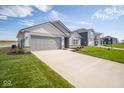 Two-story home with gray siding and attached garage at 1114 Fleming Dr, Greenfield, IN 46140