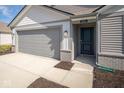 Front view of two-story home with gray siding and attached garage at 1114 Fleming Dr, Greenfield, IN 46140