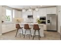 Modern kitchen with white cabinets, a kitchen island, and stainless steel appliances at 5714 Cloister Ln, McCordsville, IN 46055