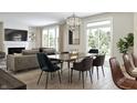 Bright dining room features a large table, modern chairs, and a view to the living room at 5714 Cloister Ln, McCordsville, IN 46055