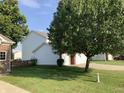 House exterior with white siding and large tree at 5211 Nicodemus Dr, Plainfield, IN 46168