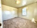 Bright bedroom featuring carpet flooring and a window with blinds at 1750 Linden St, Indianapolis, IN 46203