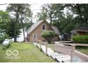 Lake house exterior with wooden stairs leading to the home at 7477 Honey Locust Dr, Nineveh, IN 46164