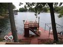 Elevated lakefront deck with stairs and seating area at 7477 Honey Locust Dr, Nineveh, IN 46164
