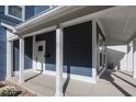 Covered front porch with white columns and blue siding at 1666 Union St, Indianapolis, IN 46225