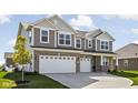 Two story home with gray siding and brick accents, two-car garage at 6429 Flag Stop Dr, Whitestown, IN 46075